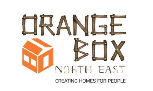Orange Box written using sticks with small orange house in bottom left corner.