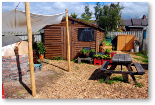Wooden shed and picnic table in the garden