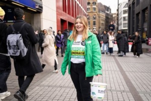 St John volunteer holding a collection bucket in busy town centre