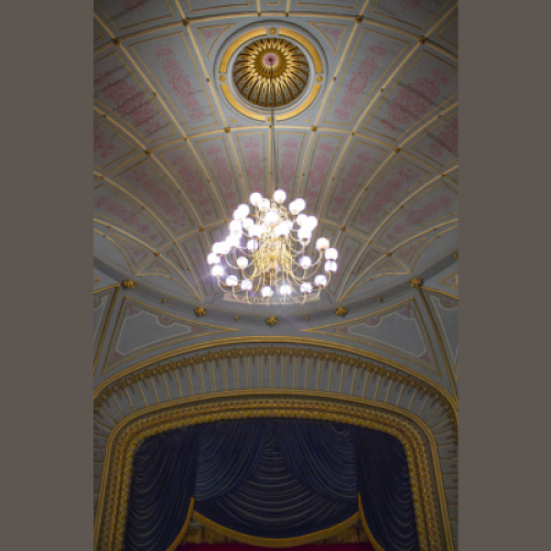 A decorative ceiling with a chandelier