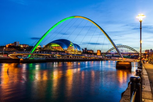 Gateshead Millennium Bridge lit orange and green