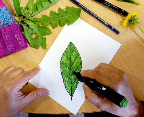 Group member joining in with a craft activity