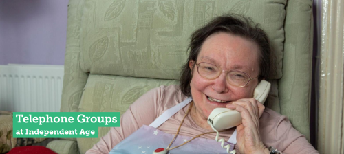 An elderly lady on the phone smiling 