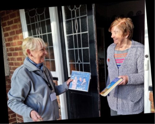 Reader being greeted with a book on their doorstep