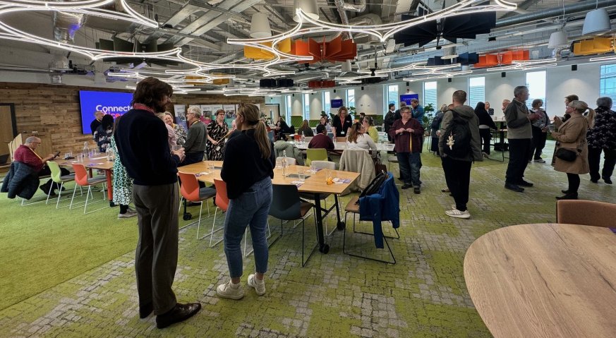 Large group of people standing and chatting