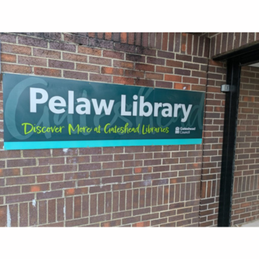 Exterior of Pelaw Library building and signage - sign says Pelaw Library discover more at Gateshead Libraries and has Gateshead Council logo.
