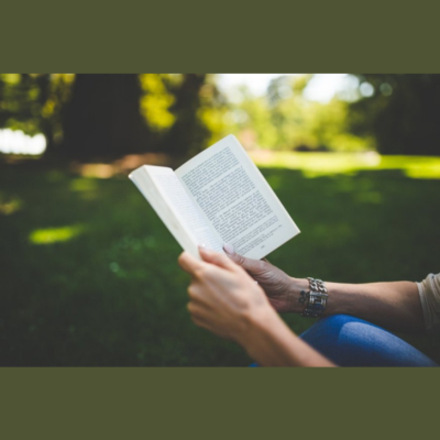 Book held open against green spaces background