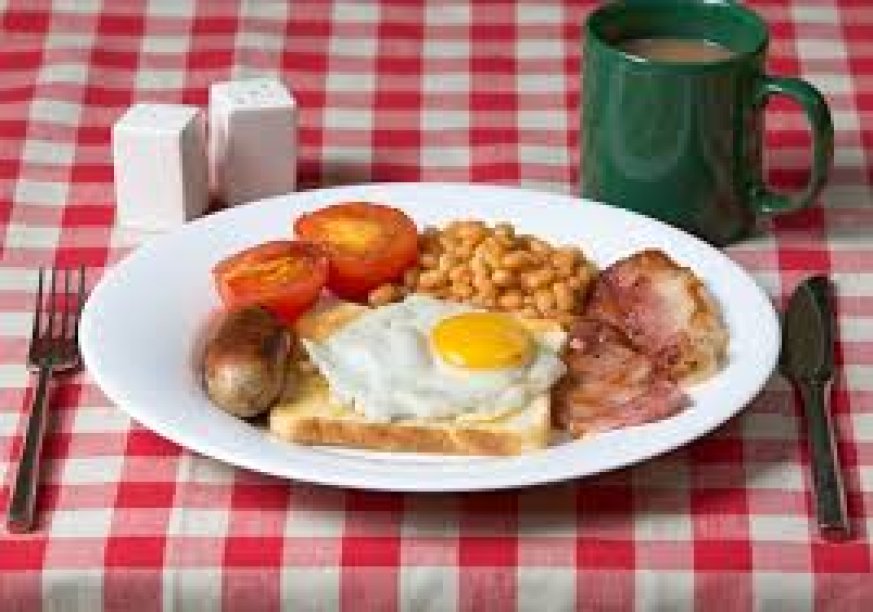 photo of a cooked breakfast on a red and white checked tablecloth