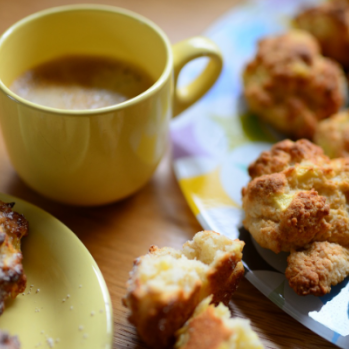 a photo of a cup of tea next to some nice looking cookies 