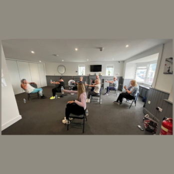 Image of people in chairs doing an exercise class
