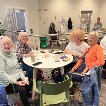 A group of people having a cup of tea.