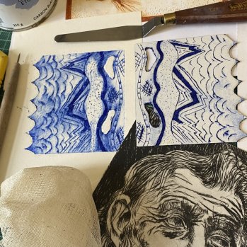 A photo that shows a landscape drawing in blue ink. Beneath it is a portrait drawing in black ink,