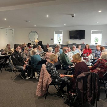 Group of people talking around tables