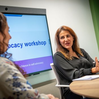 Two people talking at a table