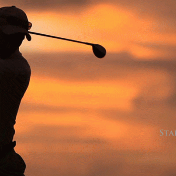 photo showing silhouette of a golfer with the sun setting behind him 