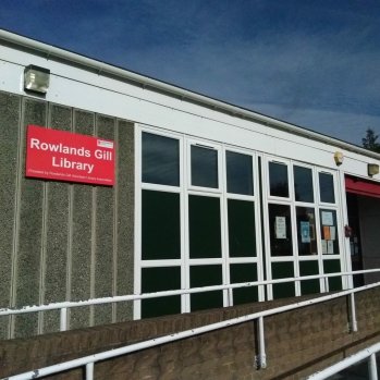 a photo of the outside of the library - a single storey glass fronted building 
