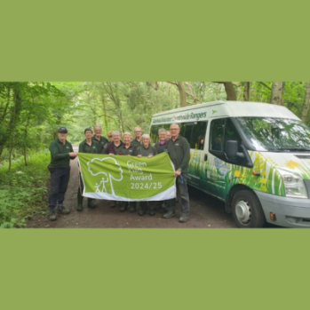 Countryside Volunteers with Green Flag and Countryside Minibus.