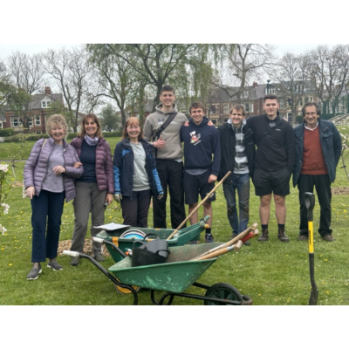 Group; of volunteers smiling after enjoying a morning's work in the orchard