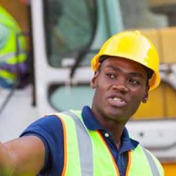 Two men in hard hats and Hi-Vis on a construction site